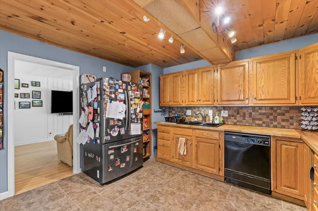 a view of a kitchen with stainless steel appliances granite countertop a stove and a sink