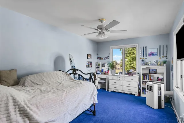 a bedroom with furniture and a window