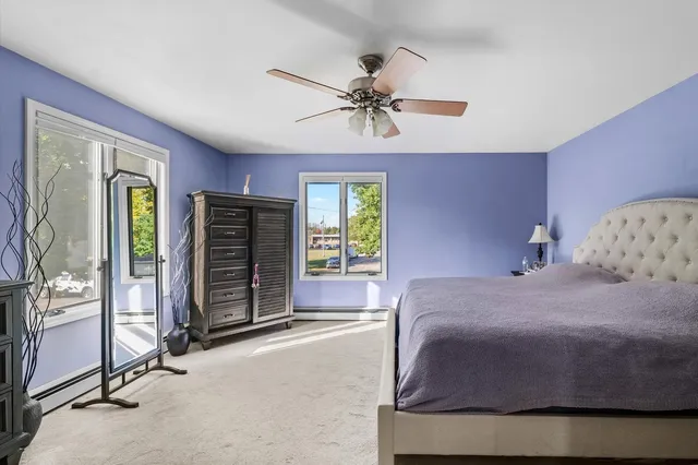 a large bedroom with a bed and a chandelier