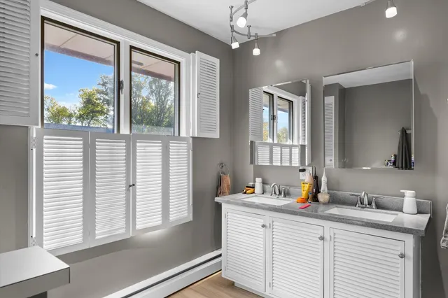 a bathroom with a sink vanity and a mirror