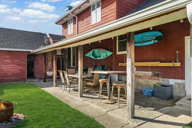 a front view of a house with garden and sitting area