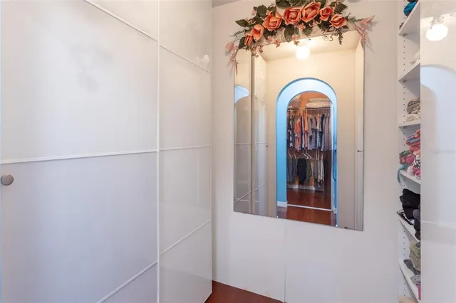 a bathroom with a tub sink and mirror