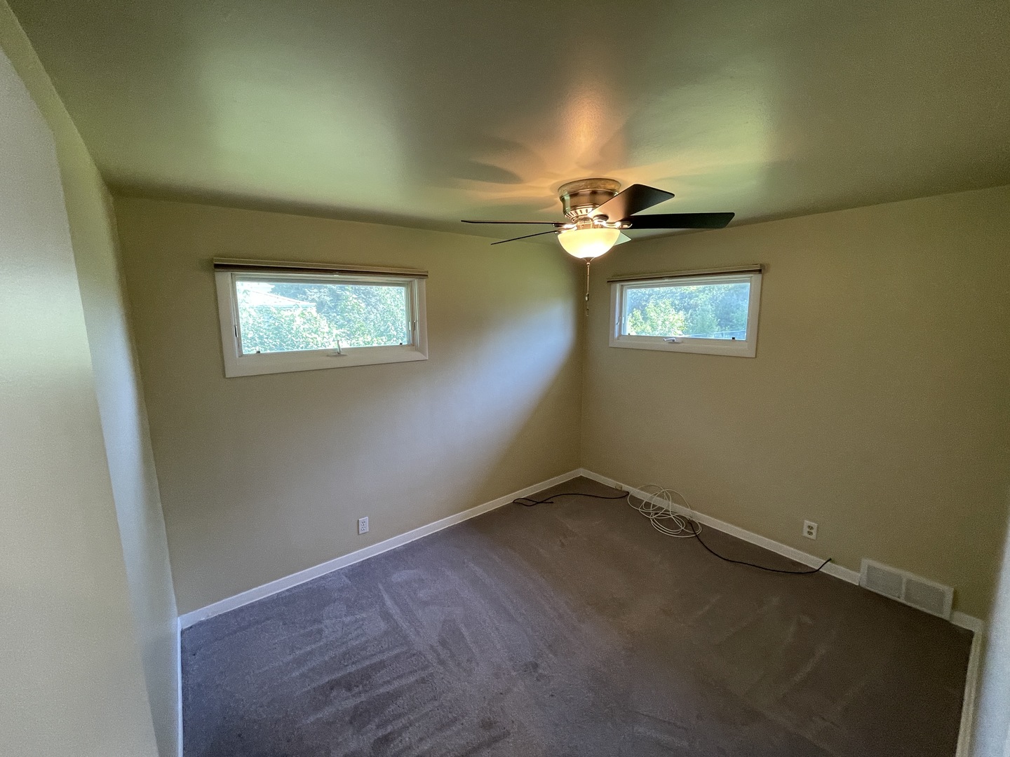 11 Shagbark Road Lake Bluff, IL 60044 - Photo 9 of 20 an empty room with windows and chandelier fan