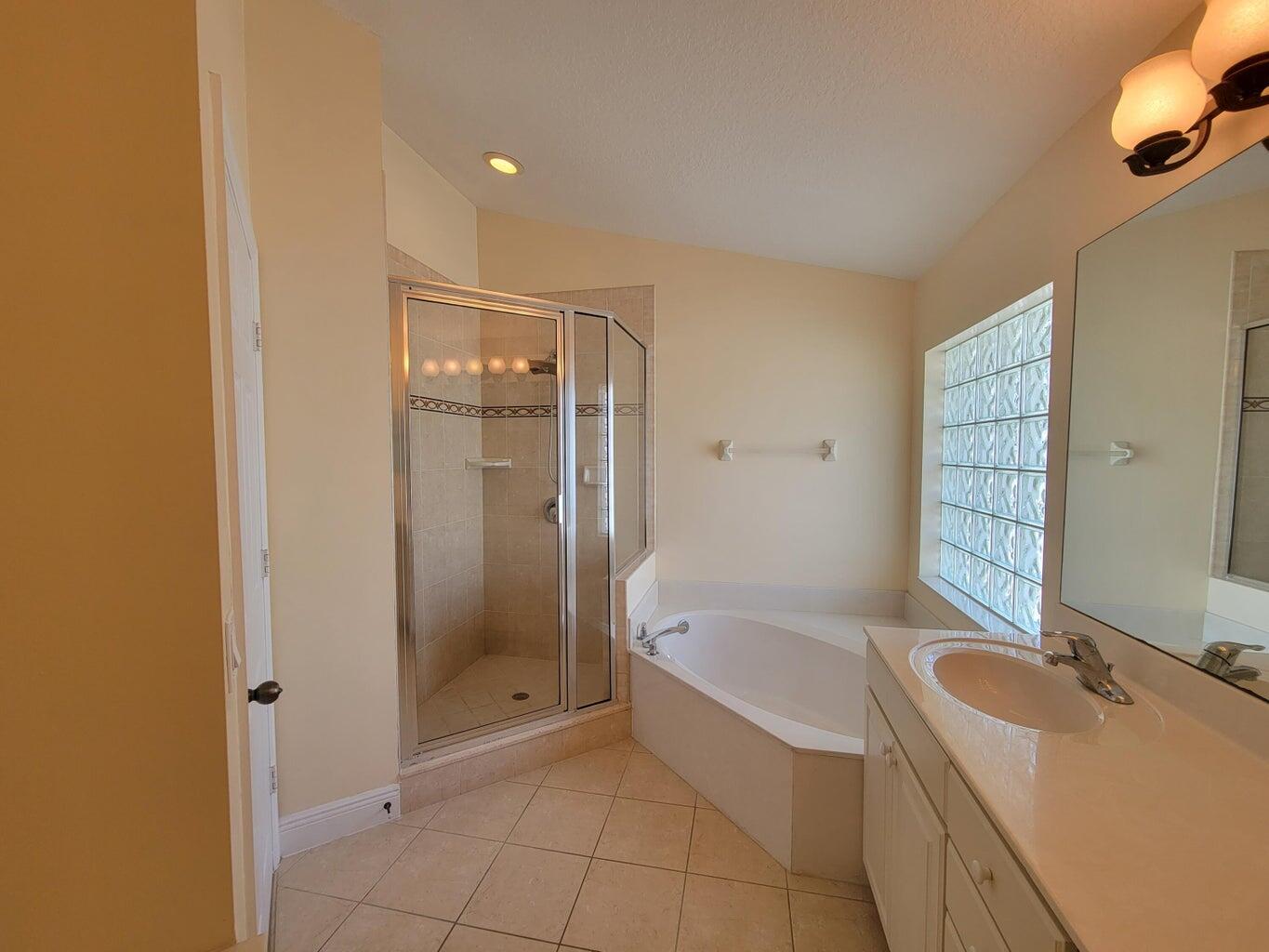 330 Clocktower Drive Jupiter, FL 33458 - Photo 15 of 19 a bathroom with a tub sink and shower