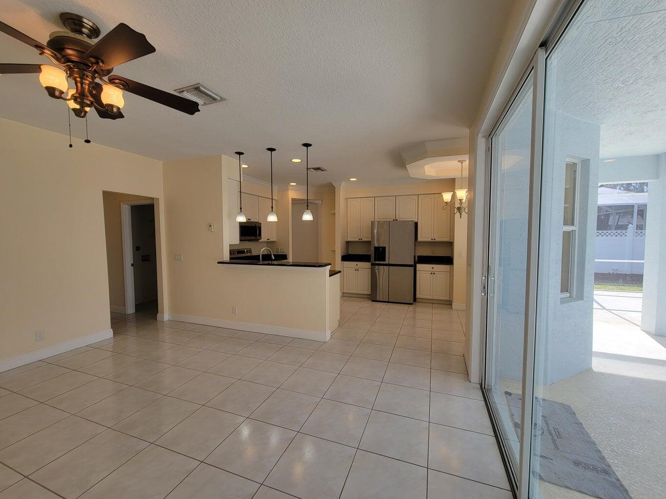 330 Clocktower Drive Jupiter, FL 33458 - Photo 5 of 19 a view of an empty room and kitchen view
