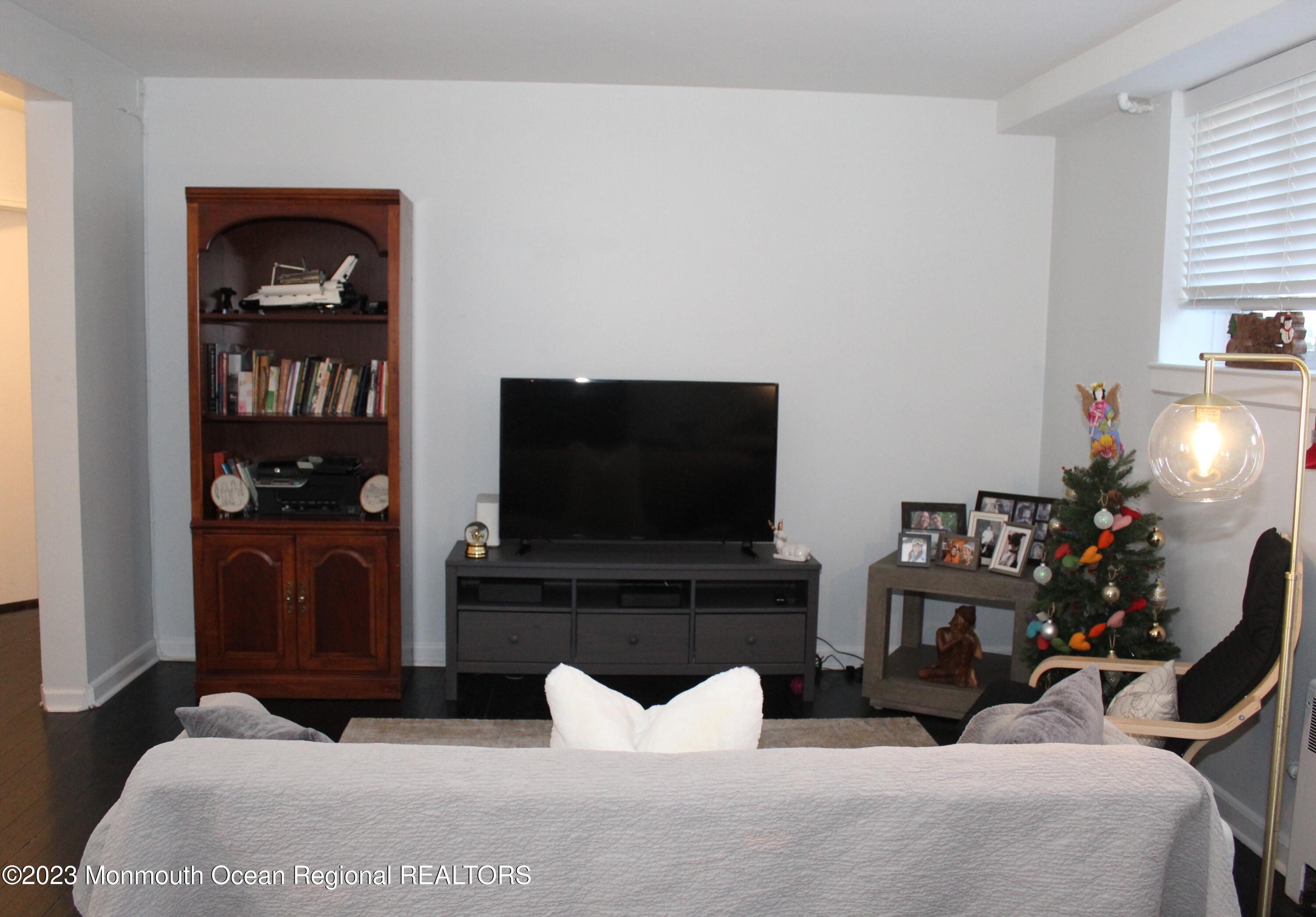 293 Spring Street, Unit 16A Red Bank, NJ 07701 - Photo 4 of 15 a living room with furniture and a flat screen tv