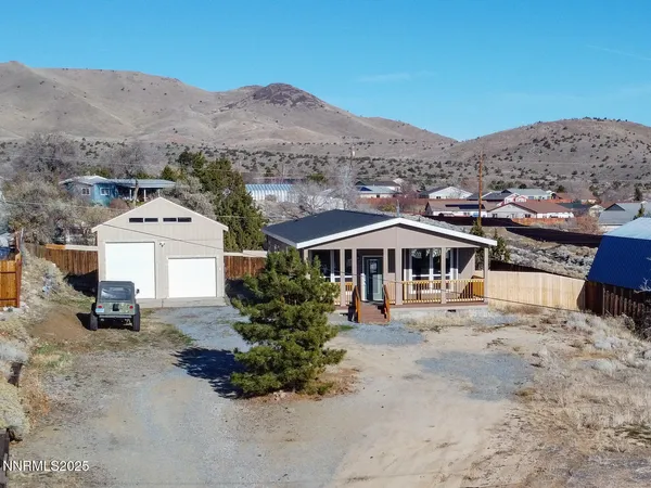 an aerial view of a house with a yard