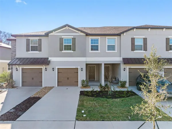 a front view of a house with a yard and garage