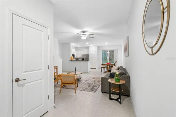 a living room with furniture and a chandelier