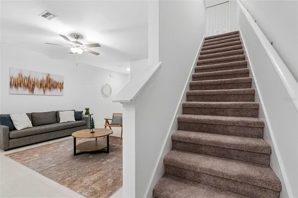 a living room with furniture and a stair