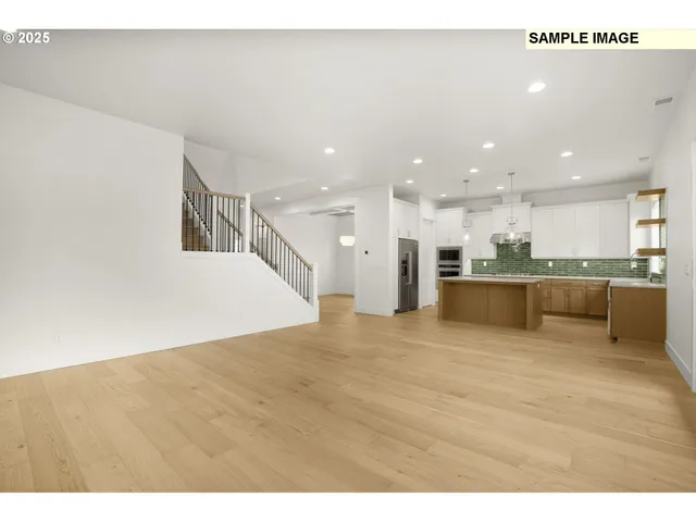 a view of kitchen with kitchen island white cabinets and refrigerator