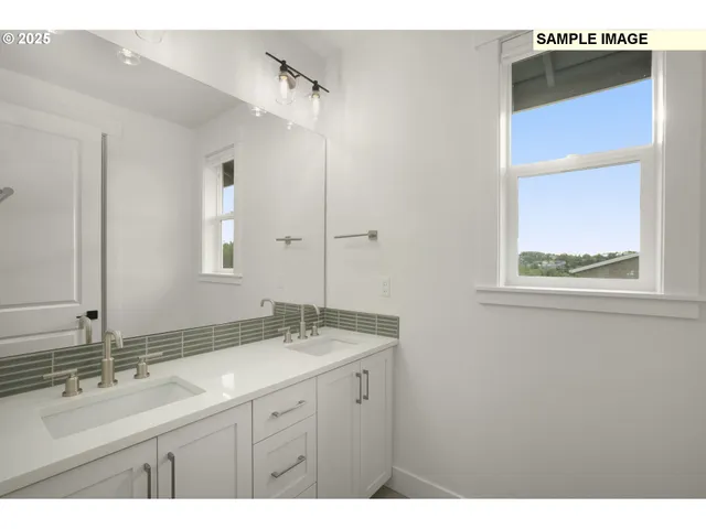 a bathroom with a double vanity sink and mirror