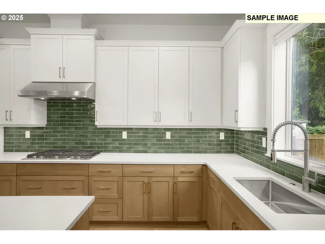 a kitchen with kitchen island granite countertop a sink a stove and cabinets