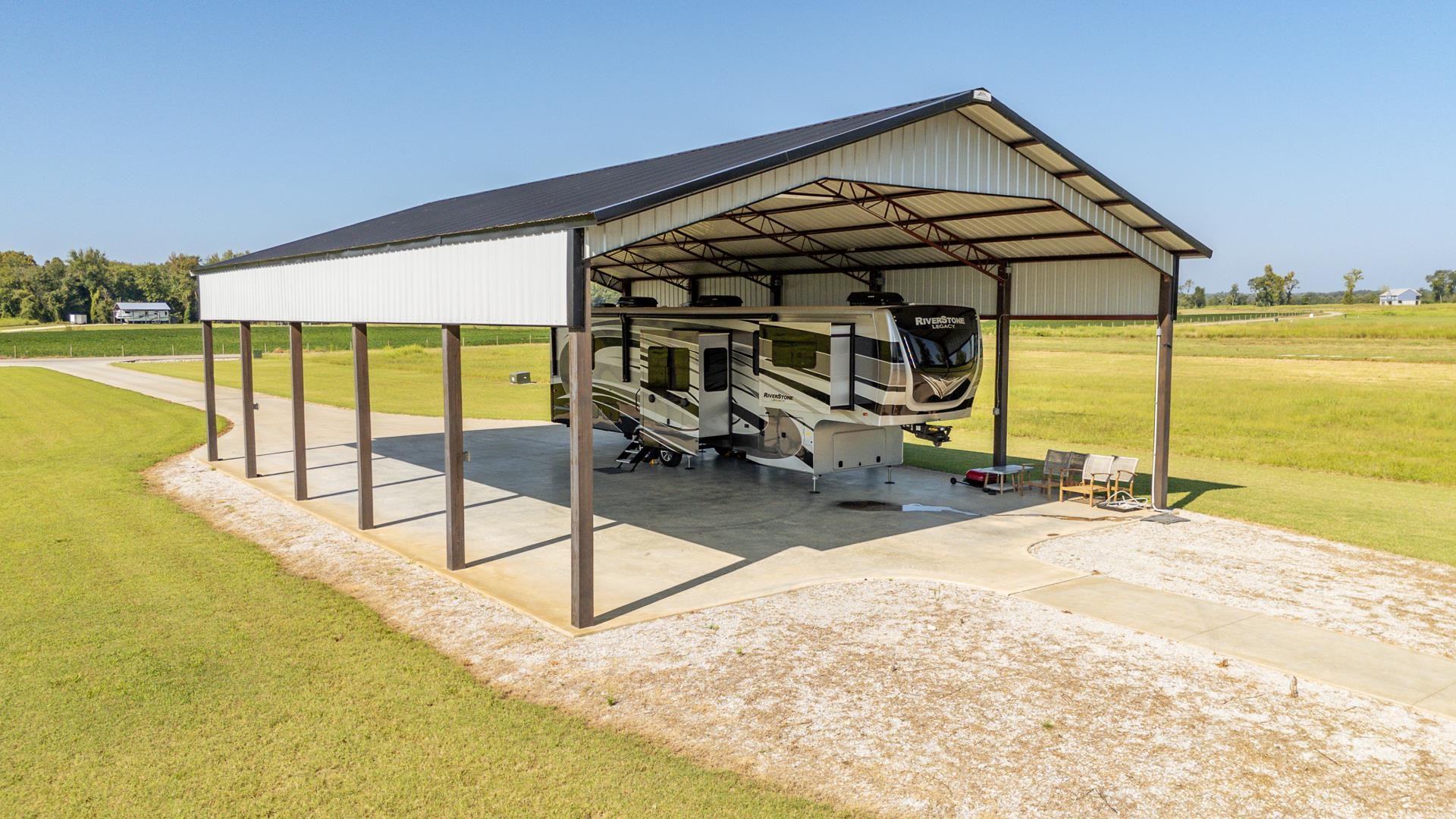 6235 Cravens Road Savannah, TN 38372 - Photo 4 of 11 View of patio / terrace featuring a rural view, a carport, and driveway