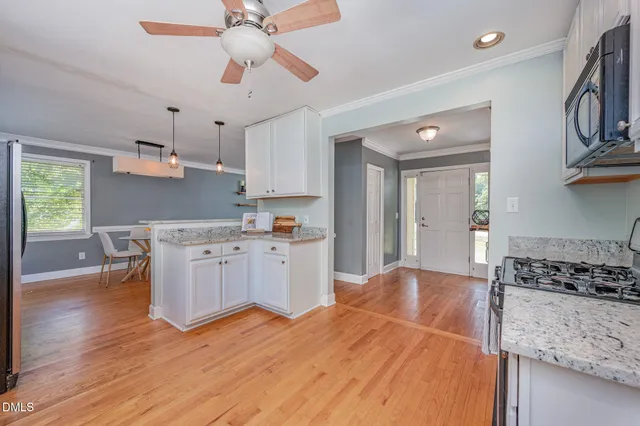 a dining room with furniture and wooden floor