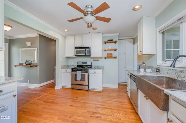 a kitchen with a stove a refrigerator and a sink