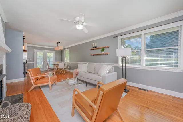 a living room with furniture and wooden floor
