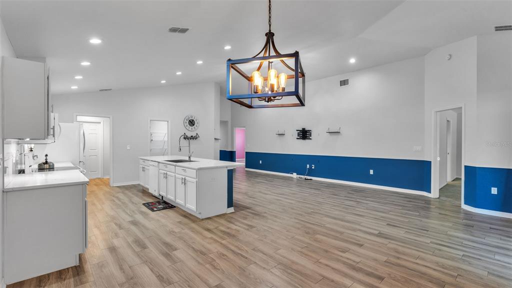 501 Interlock Street Lake Alfred, FL 33850 - Photo 11 of 49 a kitchen with sink cabinets and wooden floor