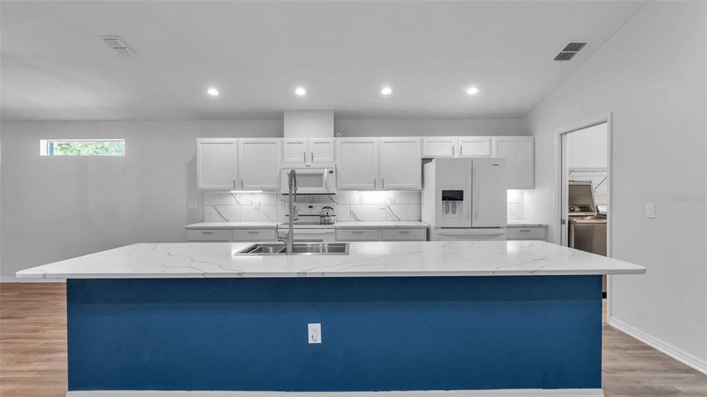 501 Interlock Street Lake Alfred, FL 33850 - Photo 13 of 49 a large kitchen with stainless steel appliances a large counter top