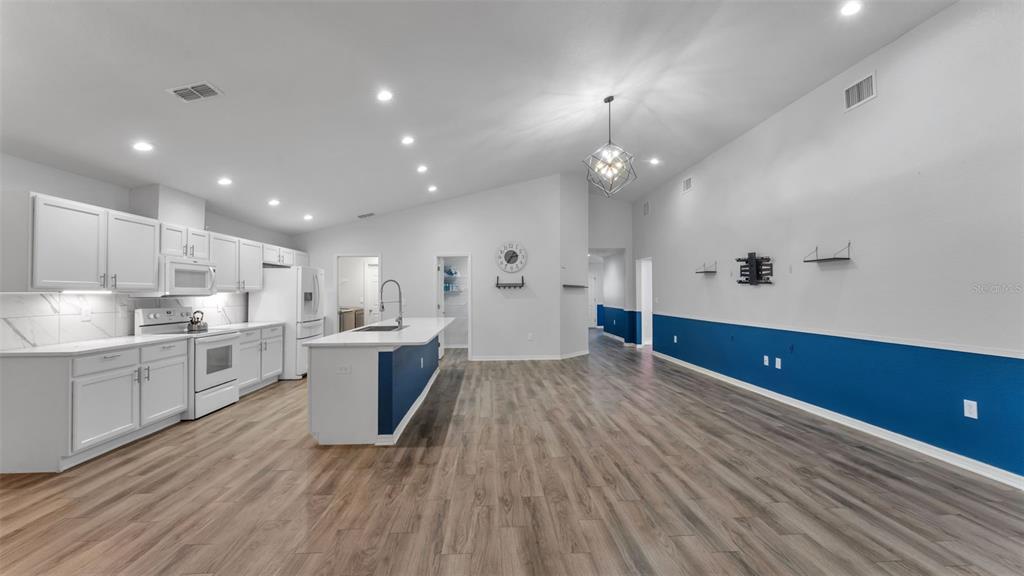 501 Interlock Street Lake Alfred, FL 33850 - Photo 21 of 49 a large kitchen with kitchen island a sink stainless steel appliances and cabinets