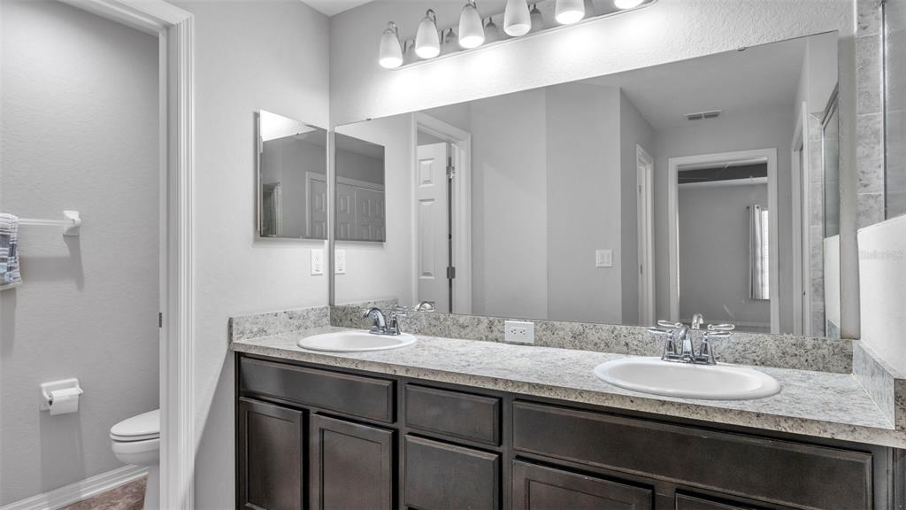 501 Interlock Street Lake Alfred, FL 33850 - Photo 27 of 49 a bathroom with a double vanity sink and a mirror