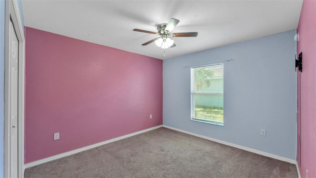 501 Interlock Street Lake Alfred, FL 33850 - Photo 33 of 49 an empty room with a ceiling fan and windows