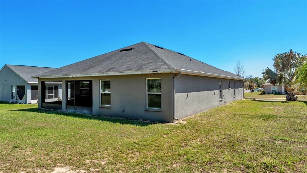 501 Interlock Street Lake Alfred, FL 33850 - Photo 41 of 49 a front view of house with yard and trees in the background
