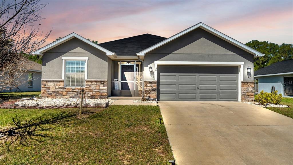 501 Interlock Street Lake Alfred, FL 33850 - Photo 42 of 49 a front view of a house with a yard and garage