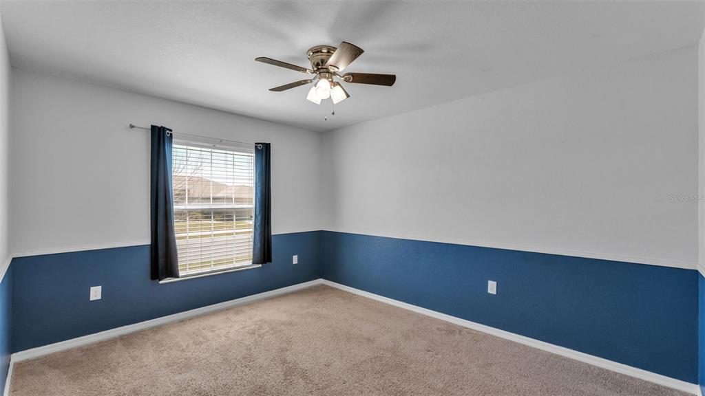 501 Interlock Street Lake Alfred, FL 33850 - Photo 6 of 49 an empty room with windows and chandelier fan