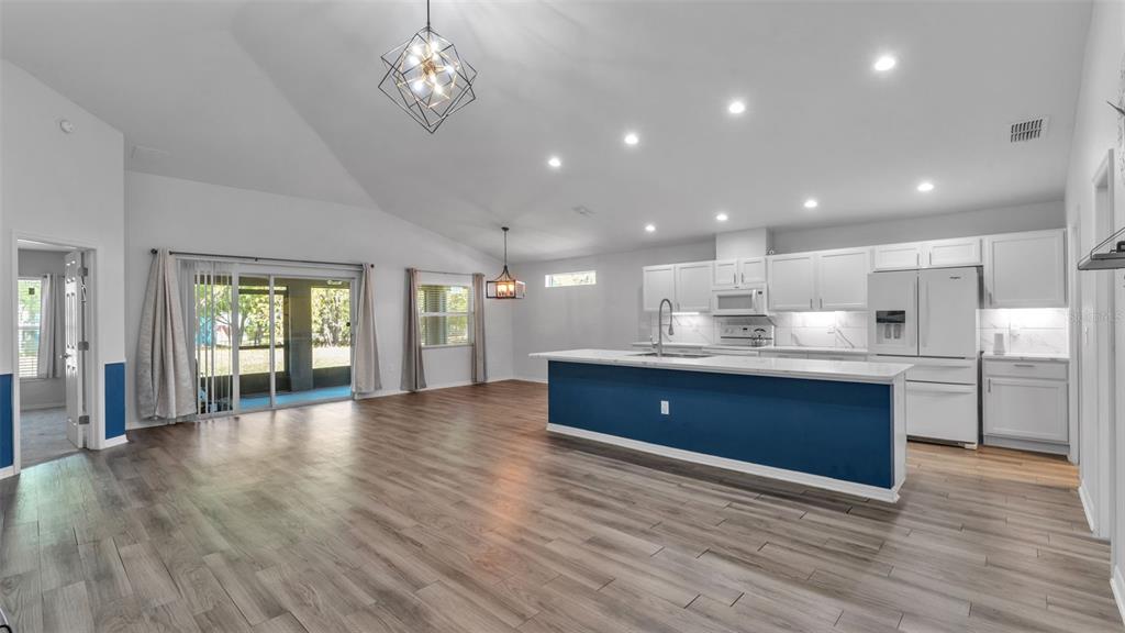 501 Interlock Street Lake Alfred, FL 33850 - Photo 8 of 49 a large kitchen with stainless steel appliances granite countertop a large counter top a sink and a refrigerator
