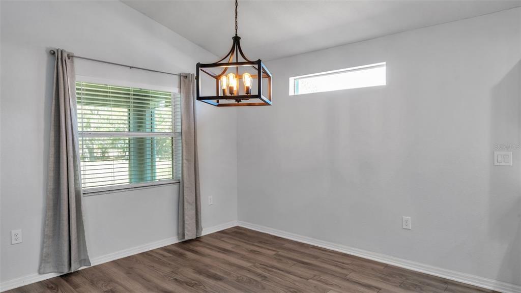 501 Interlock Street Lake Alfred, FL 33850 - Photo 10 of 49 a view of empty room with wooden floor and fan