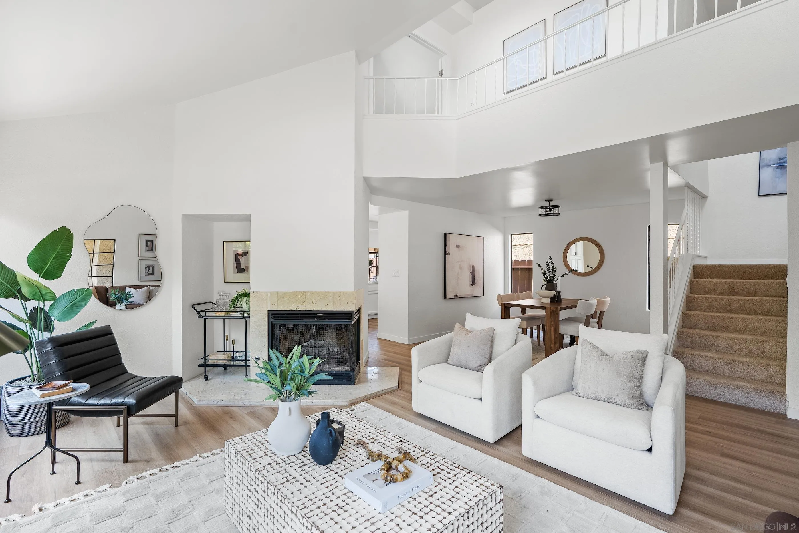 a living room with furniture a fireplace and a rug