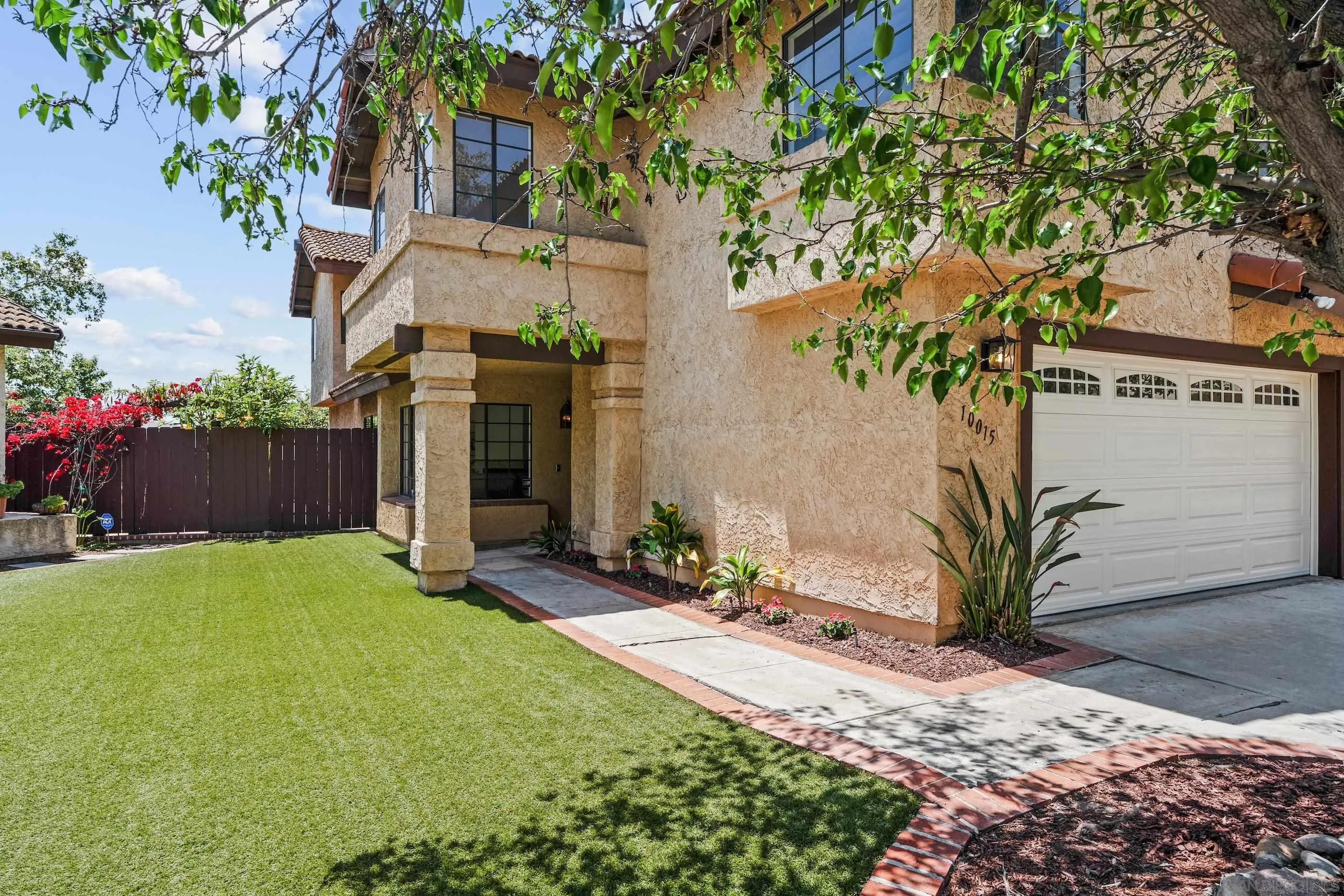 10015 Vallata Court Spring Valley, CA 91977 - Photo 16 of 33 a front view of a house with a yard and garage