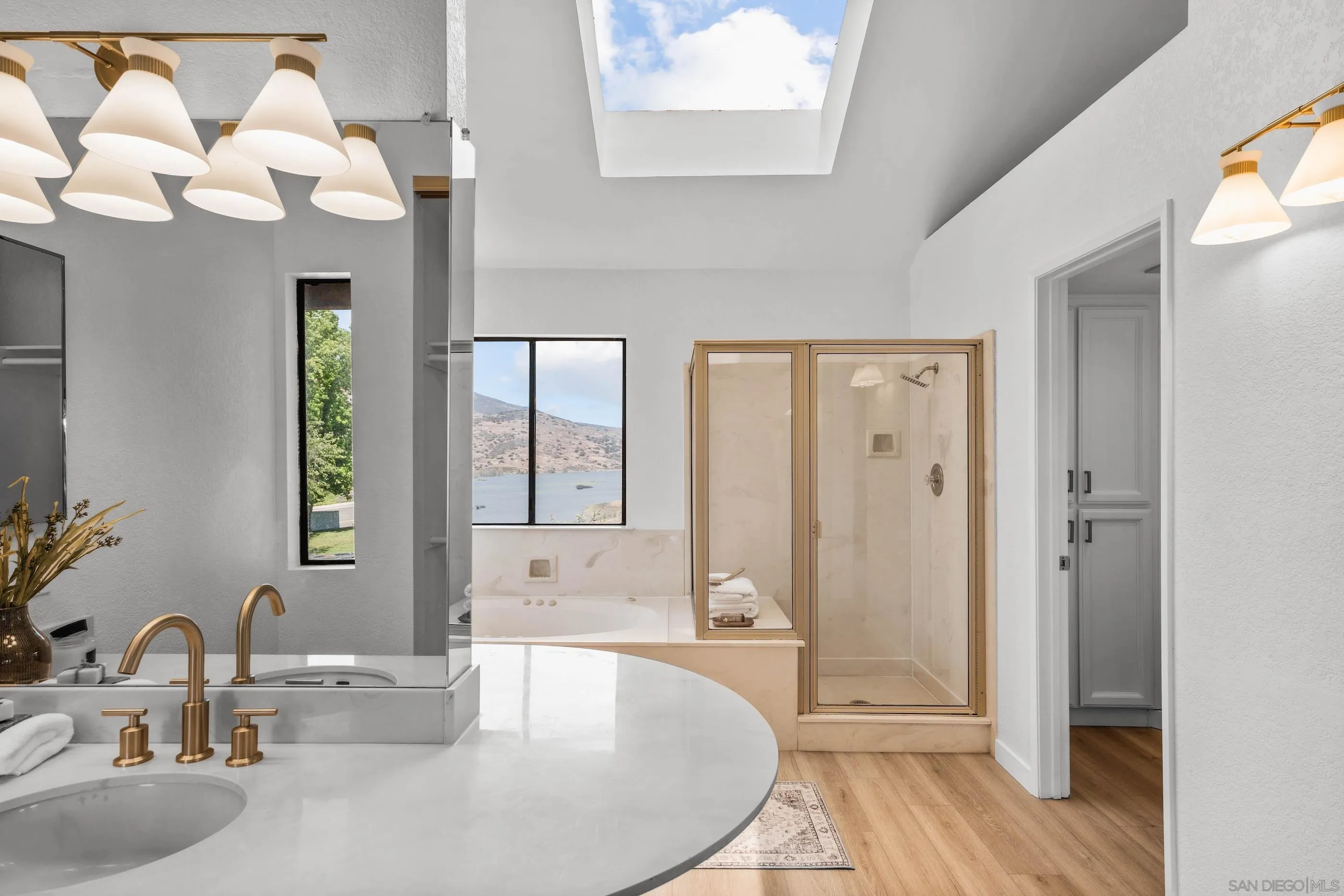 10015 Vallata Court Spring Valley, CA 91977 - Photo 22 of 33 a bathroom with a sink a mirror and a bathtub