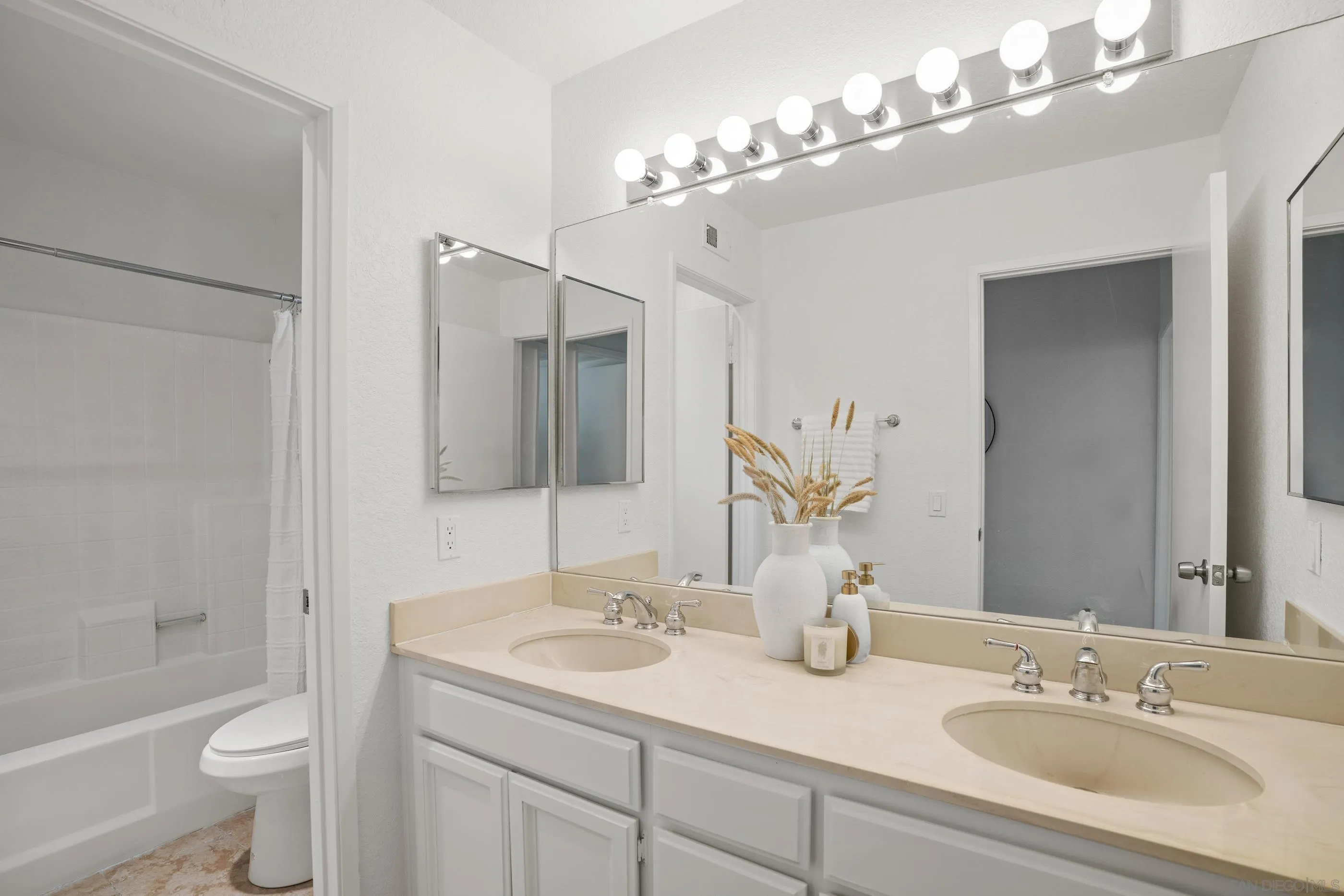 10015 Vallata Court Spring Valley, CA 91977 - Photo 25 of 33 a bathroom with a sink double vanity granite tub and a mirror
