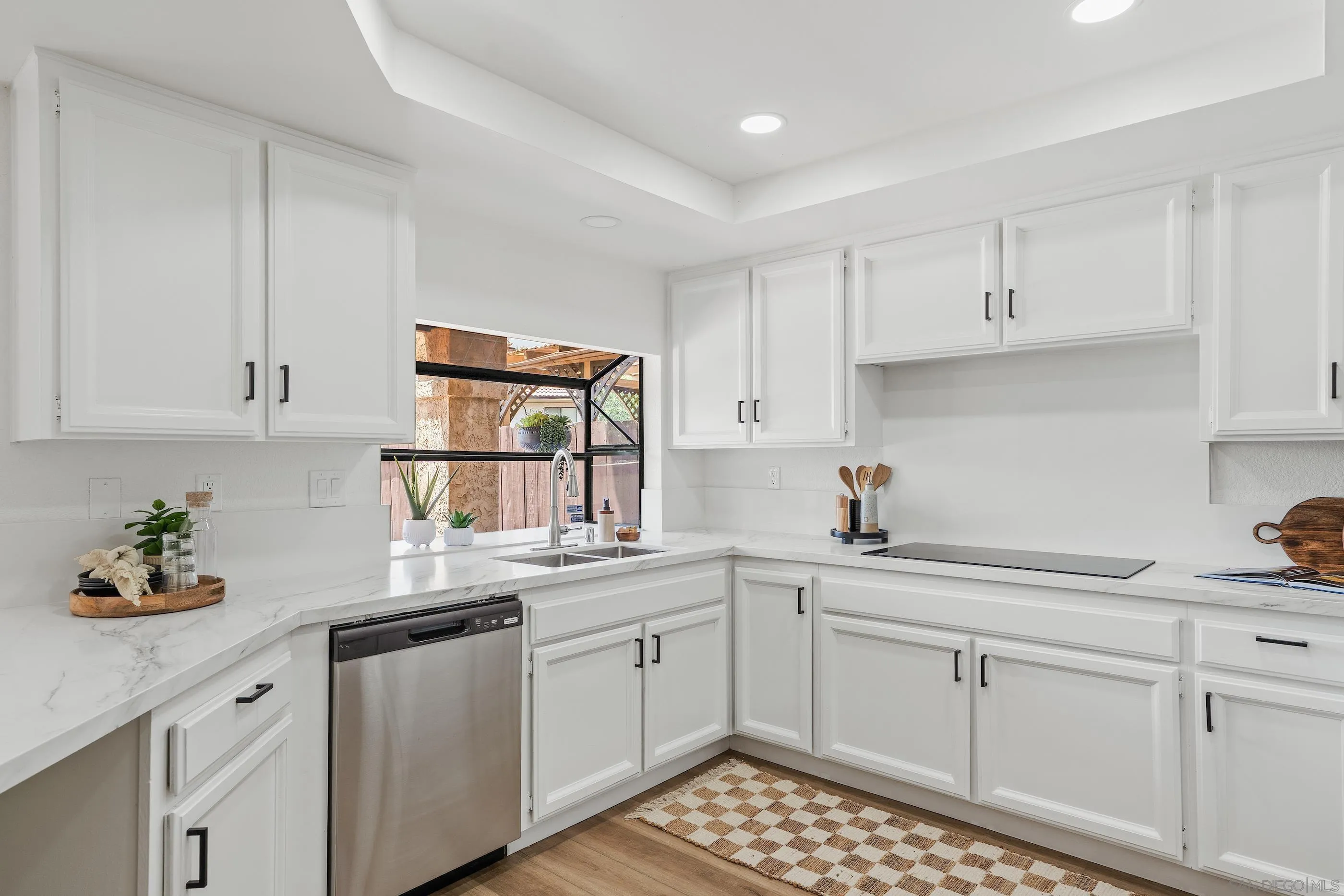 10015 Vallata Court Spring Valley, CA 91977 - Photo 7 of 33 a kitchen with a sink cabinets and window