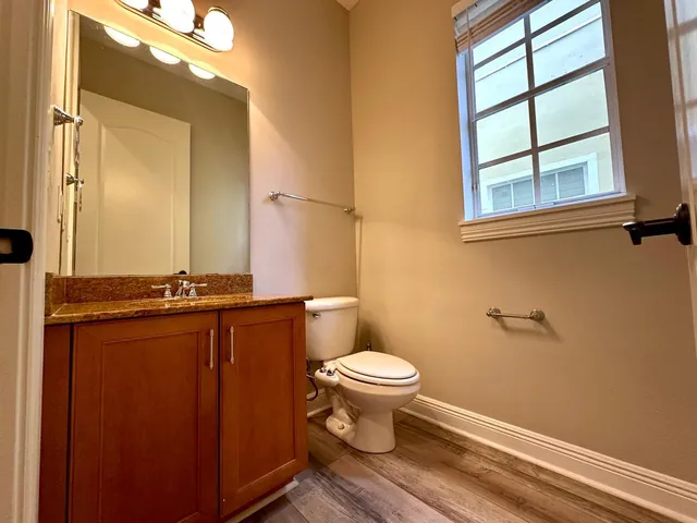 a bathroom with a toilet a sink and a mirror