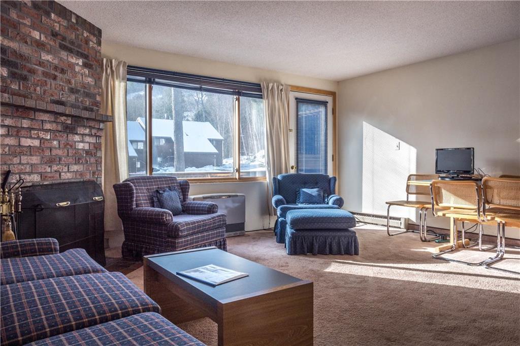 137 Ridge Run Road, Unit E2 Newry, ME 04261 - Photo 4 of 22 Wood burning fireplace in the living...