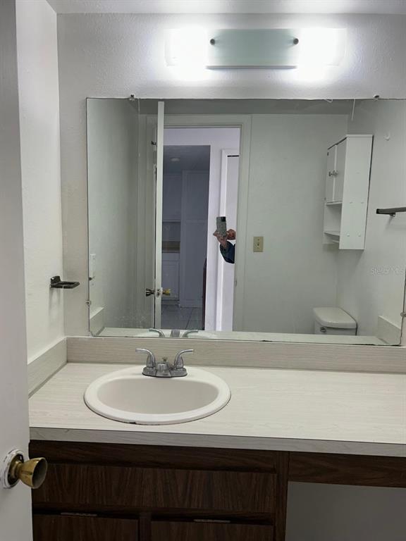 4031 Henley Road, Unit 1706 Orlando, FL 32839 - Photo 16 of 41 a bathroom with a sink and a mirror