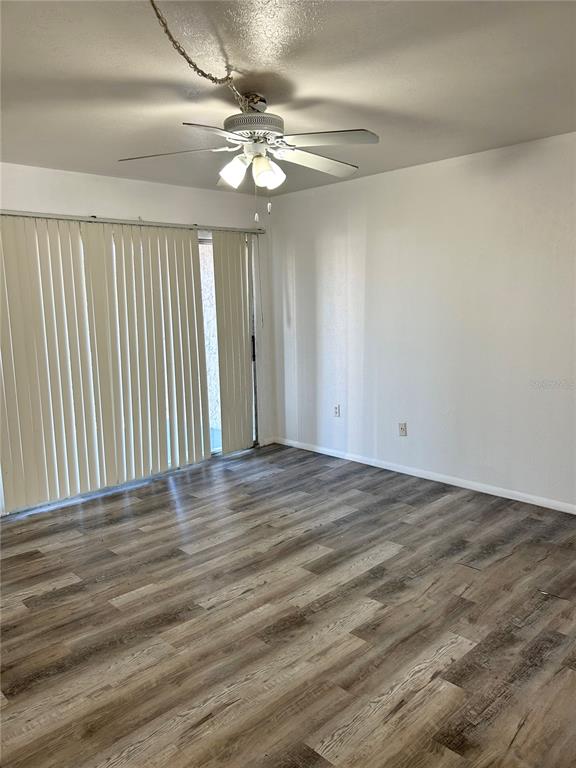 4031 Henley Road, Unit 1706 Orlando, FL 32839 - Photo 32 of 41 en empty room with wooden floor fan and window