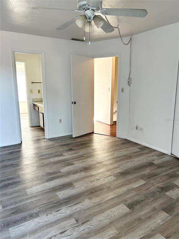 4031 Henley Road, Unit 1706 Orlando, FL 32839 - Photo 34 of 41 an empty room with wooden floor and windows