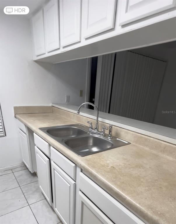 4031 Henley Road, Unit 1706 Orlando, FL 32839 - Photo 8 of 41 a kitchen with a sink and cabinets