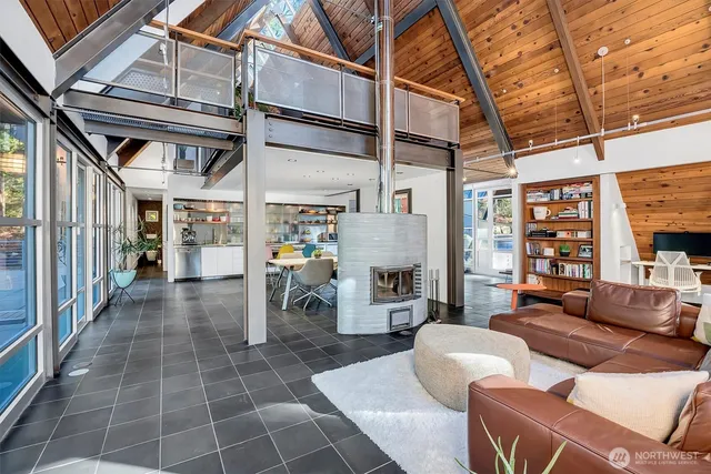 a dining room with furniture a chandelier and wooden floor