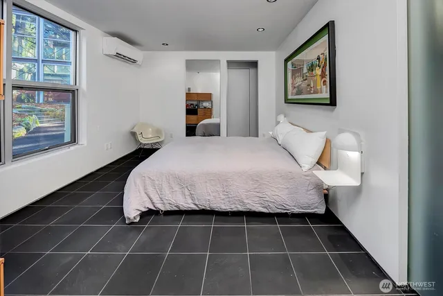 a bed sitting in a bedroom next to a window