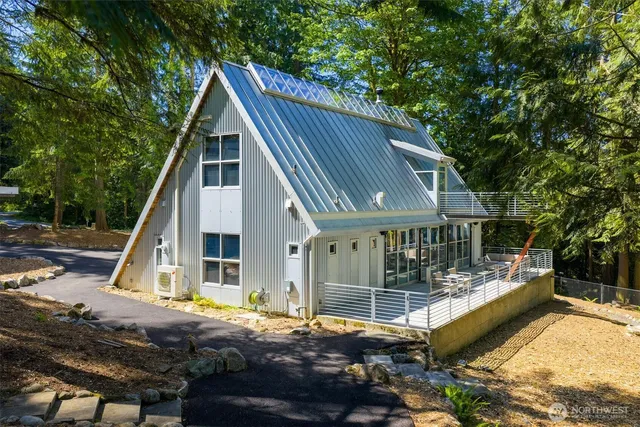 a view of a house with wooden deck and furniture