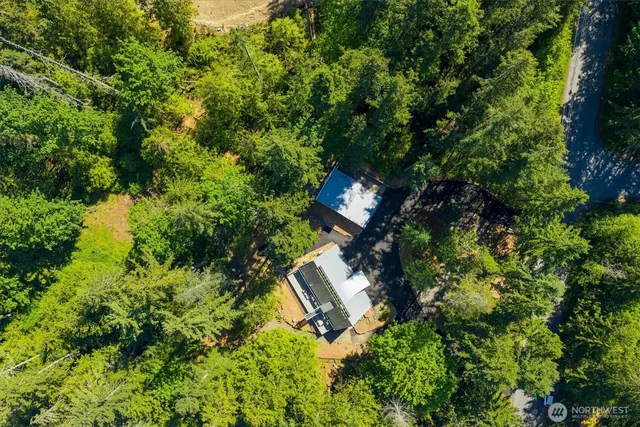 an aerial view of a house with a yard