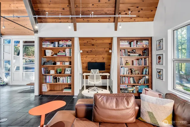 a living room with large couches and a book shelf