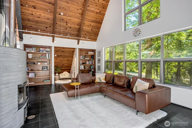 a living room with furniture and a floor to ceiling window