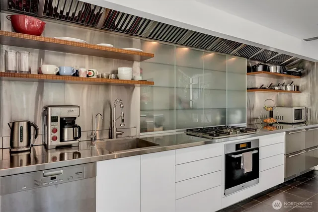 a kitchen with stainless steel appliances a sink and cabinets