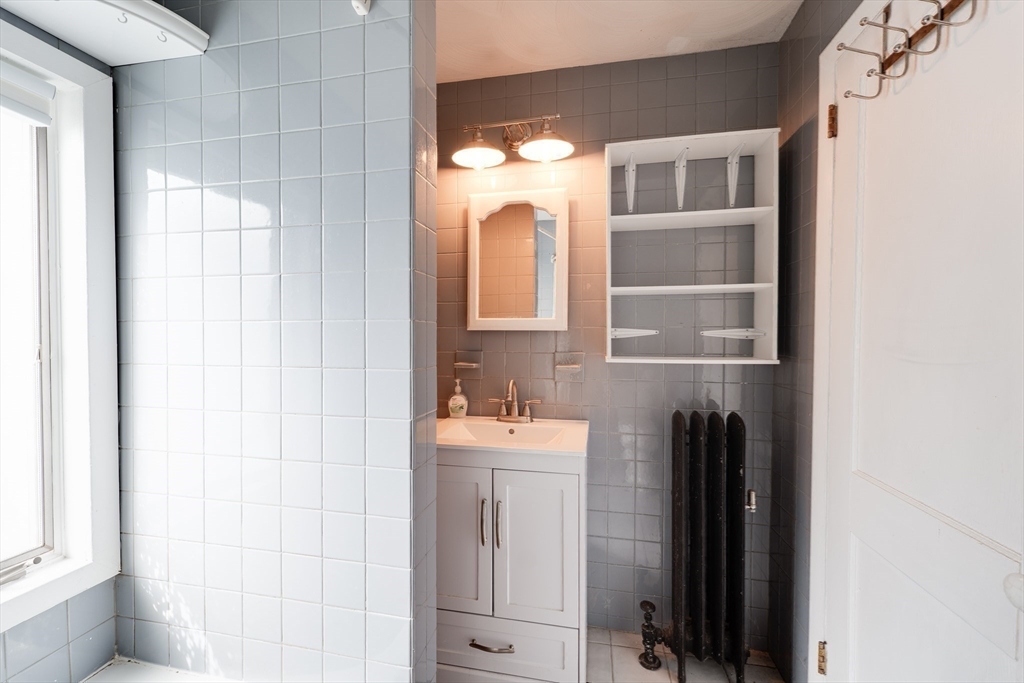 60 Blake Street Springfield, MA 01108 - Photo 13 of 30 a bathroom with a sink and a mirror